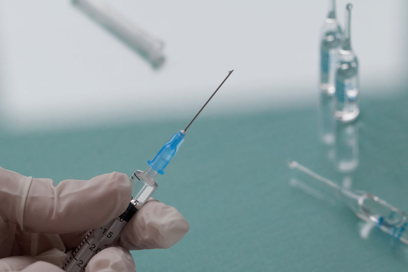doctor holds a syringe with a injection - Thoracic Epidural Steroid Injection