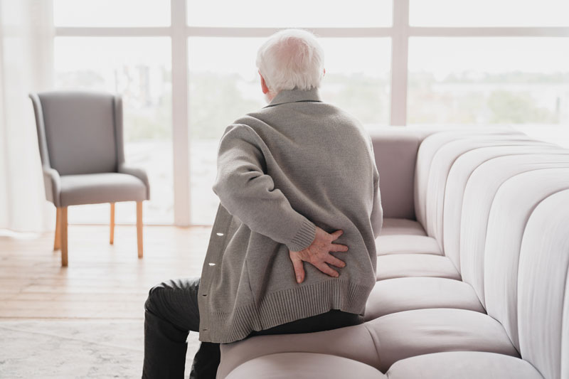 grandfather touching his back suffering from back